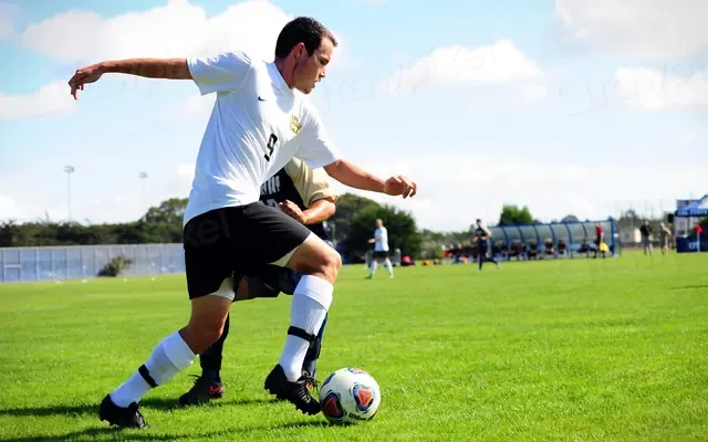 Footballer striking the ball